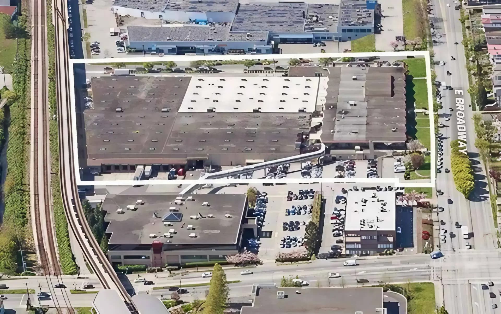 Aerial view of a warehouse site beside a rail line