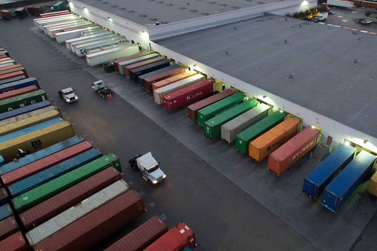 A large warehouse with many different colored containers.